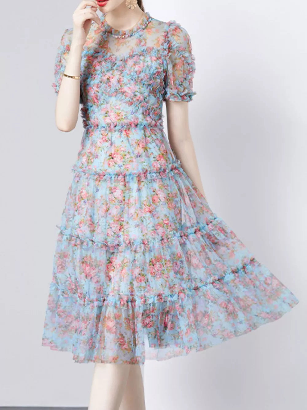 Light blue floral ruffled tiered midi dress with sheer short sleeves and mock neck.