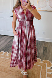 Gingham zip-front midi dress in cerise with elastic waist and pockets.
