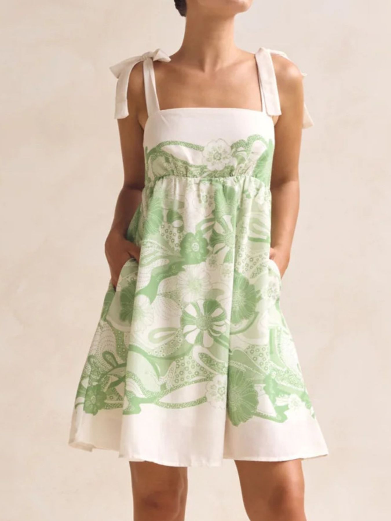 Green floral tie-strap mini dress with pockets and square neckline
