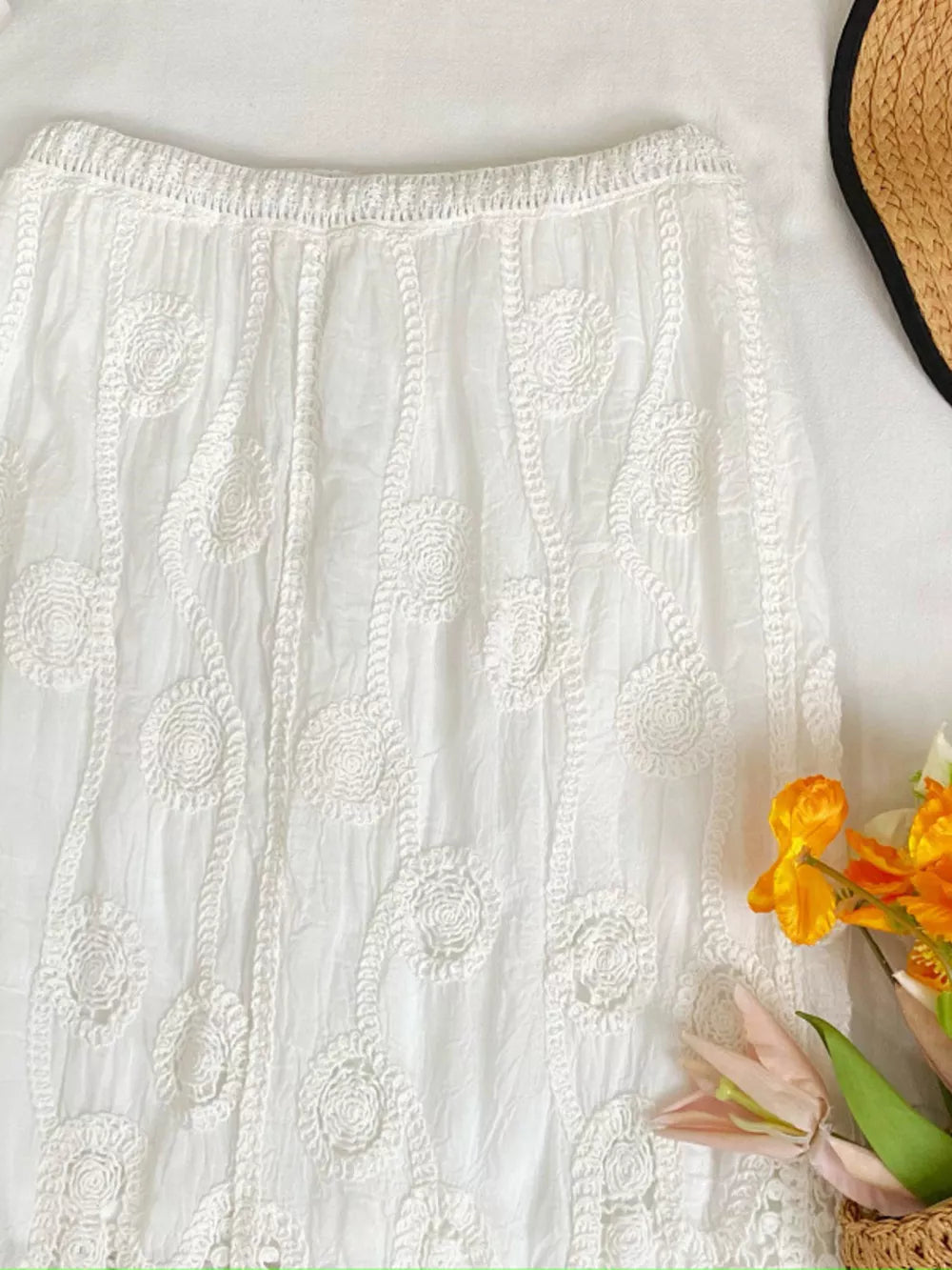 White midi skirt with elastic waist and crochet floral detail