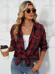 Oversized red and black plaid shacket with buttoned pockets and a knotted hem.