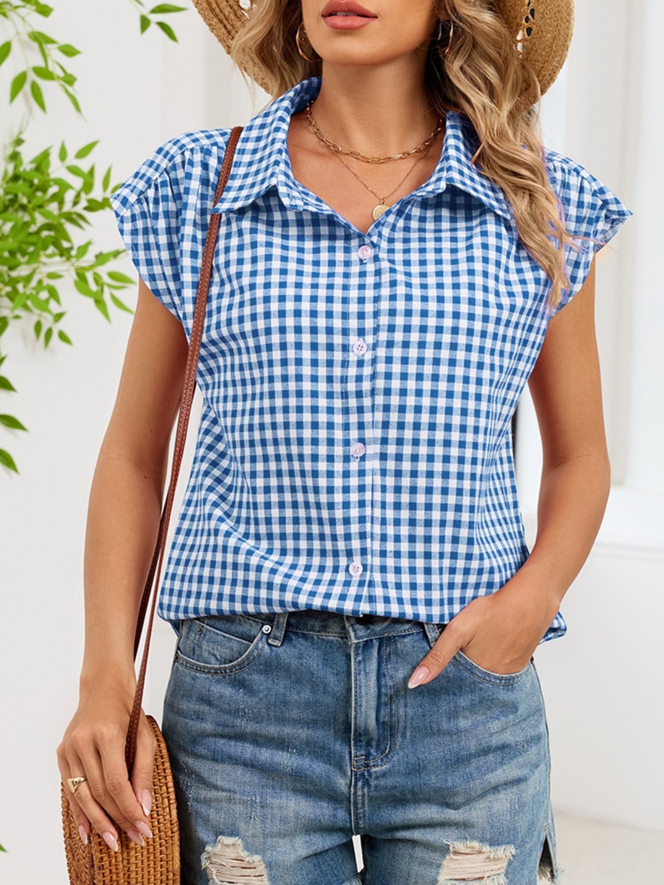 Blue gingham cotton shirt with cap sleeves and button-down front.