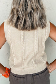 Beige cable knit vest with intricate braided detailing and ribbed trim.