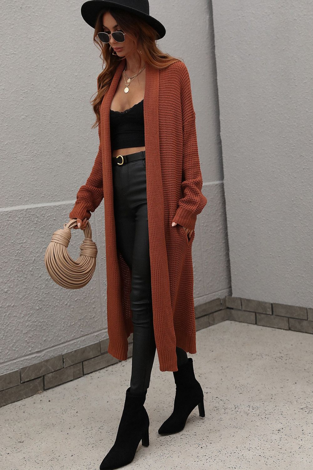 Textured knit maxi cardigan in brown with open front and pockets.