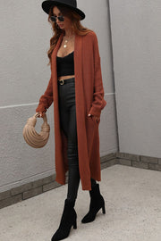 Textured knit maxi cardigan in brown with open front and pockets.