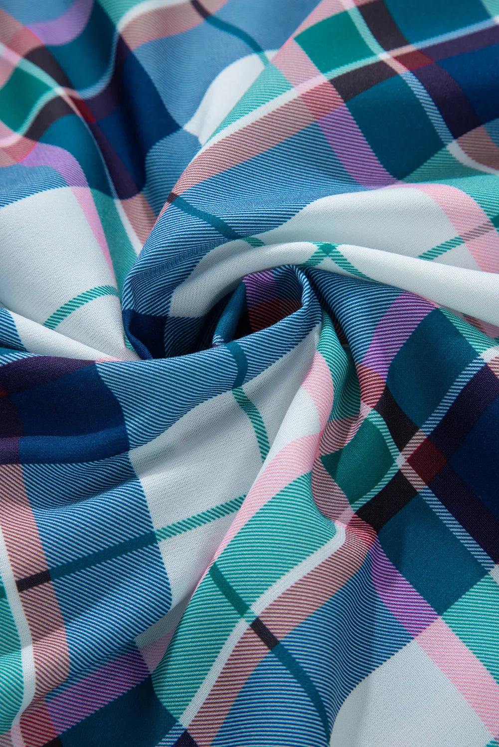 Plaid pajama fabric with ruffled hem detail in blue, pink, green, and white.