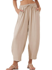Tan balloon trousers with drawstring waist and sculpted seam detail.
