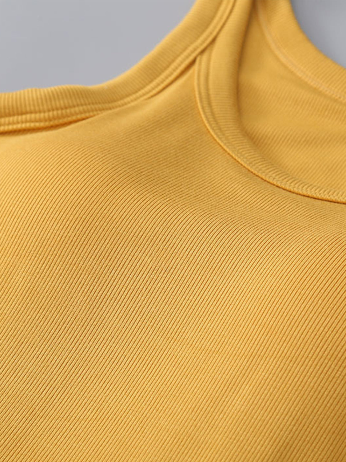 Mustard ribbed knit tank top with built-in bra detail and rounded neckline.