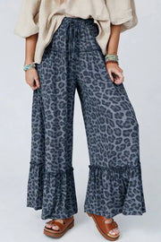 Leopard print maternity pants in dark navy with ruffled wide legs and drawstring waist.