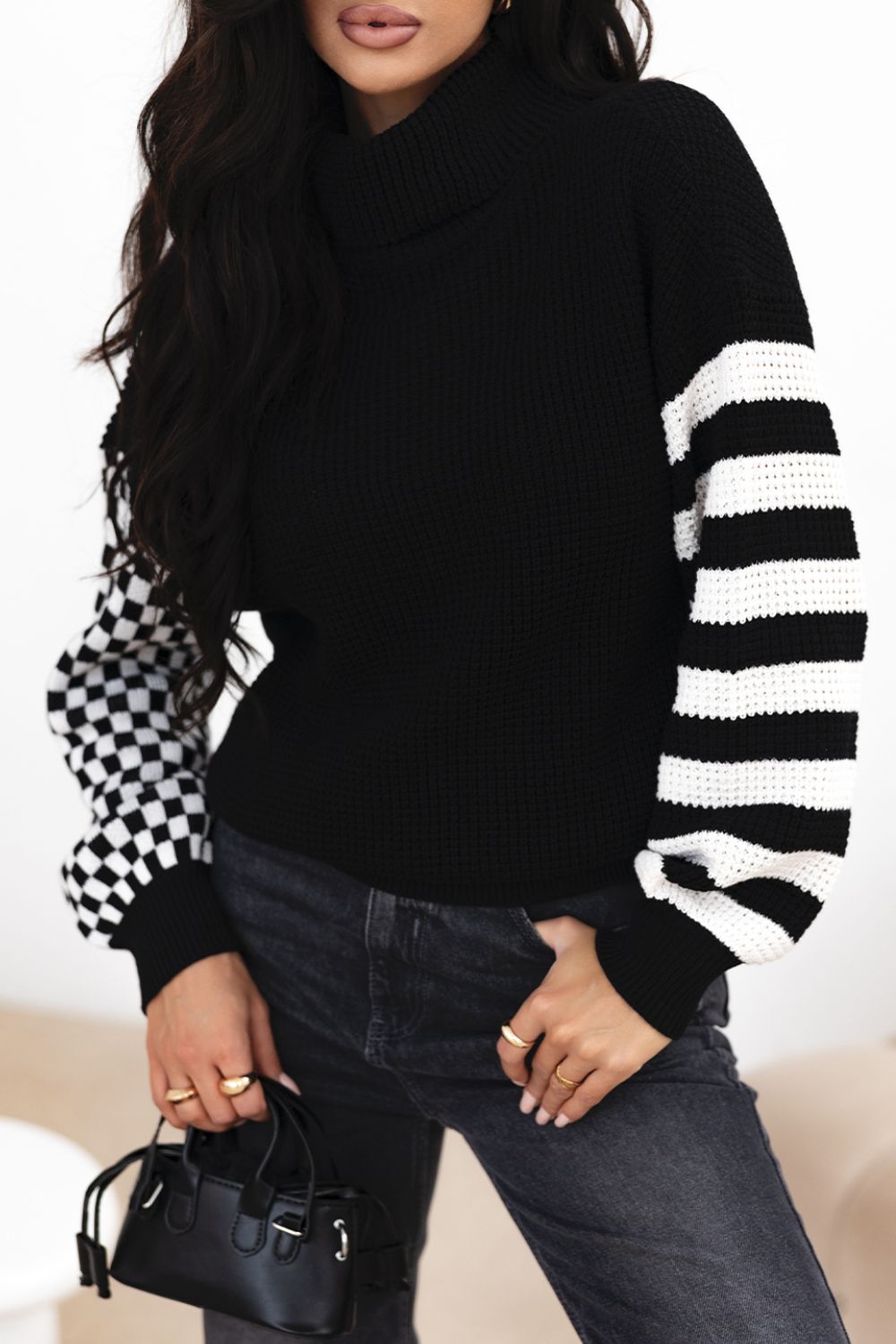 Black turtleneck sweater with checkerboard and stripe sleeves, acrylic knit.