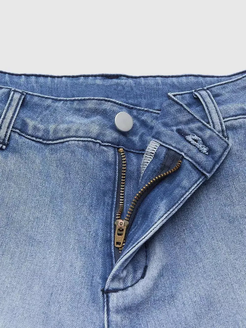 Relaxed high-waisted denim jeans in light blue wash with button and zipper closure.