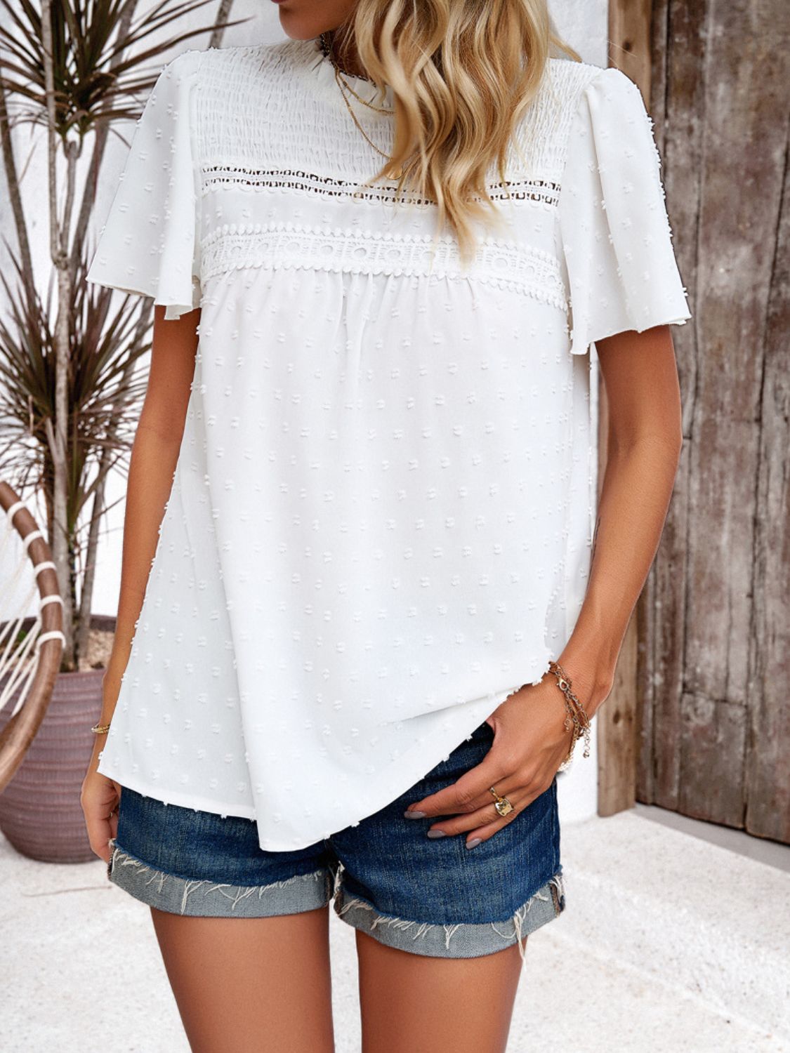 White dotted swiss smocked bodice flutter sleeve blouse with lace trim detail