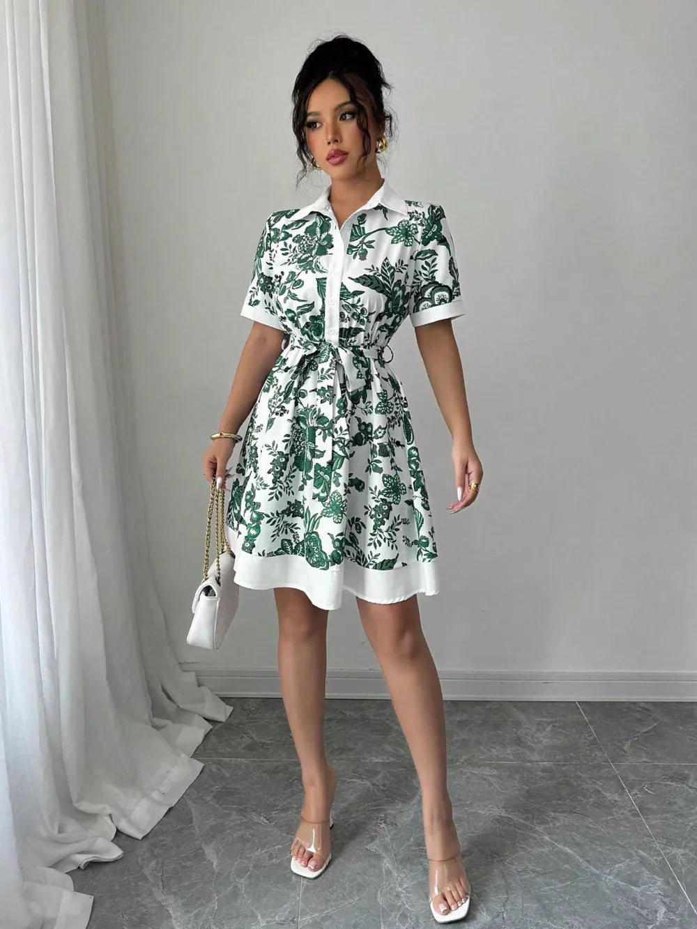 Dark green floral print mini shirt dress with tie belt and short sleeves.