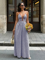 Elegant halter neck striped maxi dress with plunging neckline and brown trim.