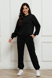 Black corduroy lounge set with crew neck sweatshirt and jogger pants, featuring a chest pocket.