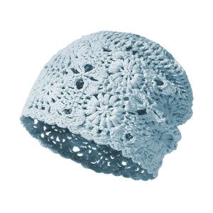 Crochet floral slouchy beanie in blue with open knit pattern.