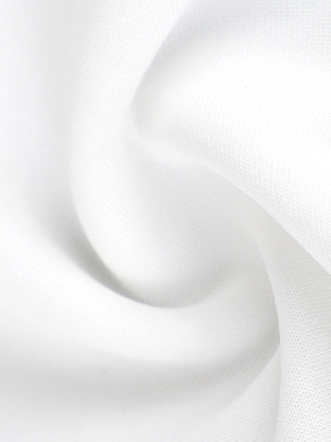 Elegant white mini dress fabric detail with soft ruffles.