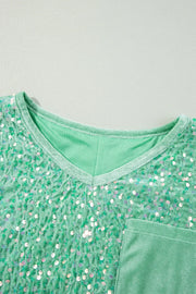 Sequin embellished dolman sleeve top in gum leaf green with V-neck and chest pocket.