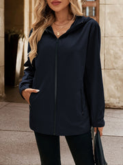 Navy zip-through hooded jacket with pockets, worn by a woman.