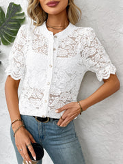 White floral lace blouse with mandarin collar and short puff sleeves.