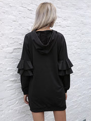 Black hooded mini dress with tiered ruffle trim sleeves.