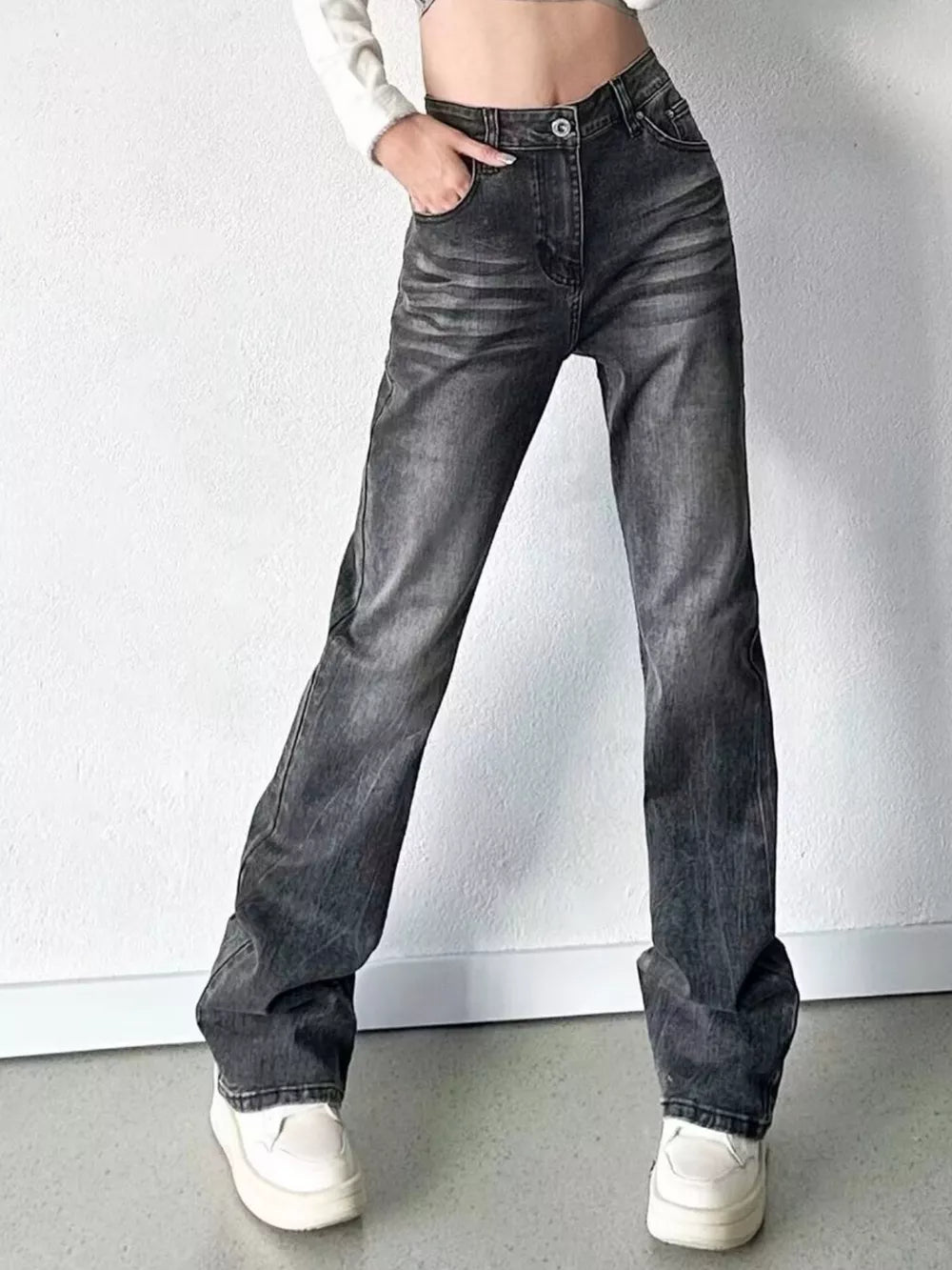 Men's black vintage high-waisted straight leg jeans with button closure and faded wash.