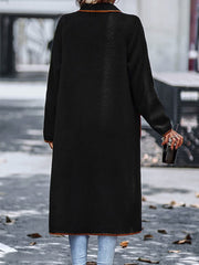 Black teddy coat with contrast trim detailing and long sleeves.