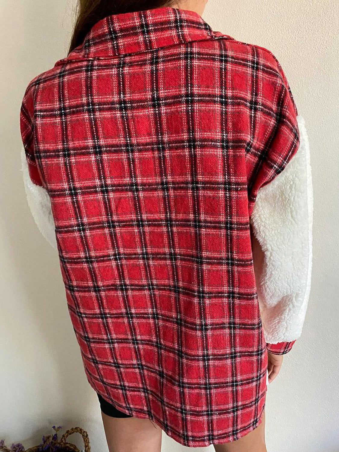 Plaid shacket with sherpa sleeves in red and black plaid.