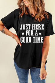 Black graphic tee with white text that reads Just Here For A Good Time, short sleeves, cotton blend.