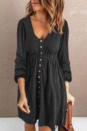 Button-down empire waist mini dress in black with V-neck and long sleeves