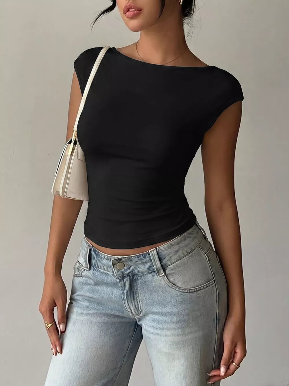 Black cap-sleeve t-shirt with lace trim and boat neck.