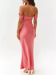 Coral satin off-shoulder maxi gown with draped neckline and bodycon fit.