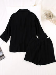 Black gauze cotton resort shirt and shorts set with a collared neckline and buttoned front.