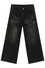 Faded black denim palazzo trousers with a wide leg and distressed details.