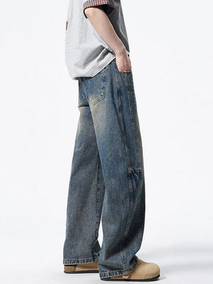Men's light wash wide-leg denim jeans with vintage distressing and a relaxed fit.