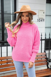 Fluffy pink mock neck sweater with long sleeves and a relaxed fit.