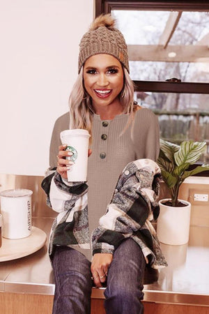 Khaki waffle knit tunic with button detail and boat neck, styled with plaid shirt