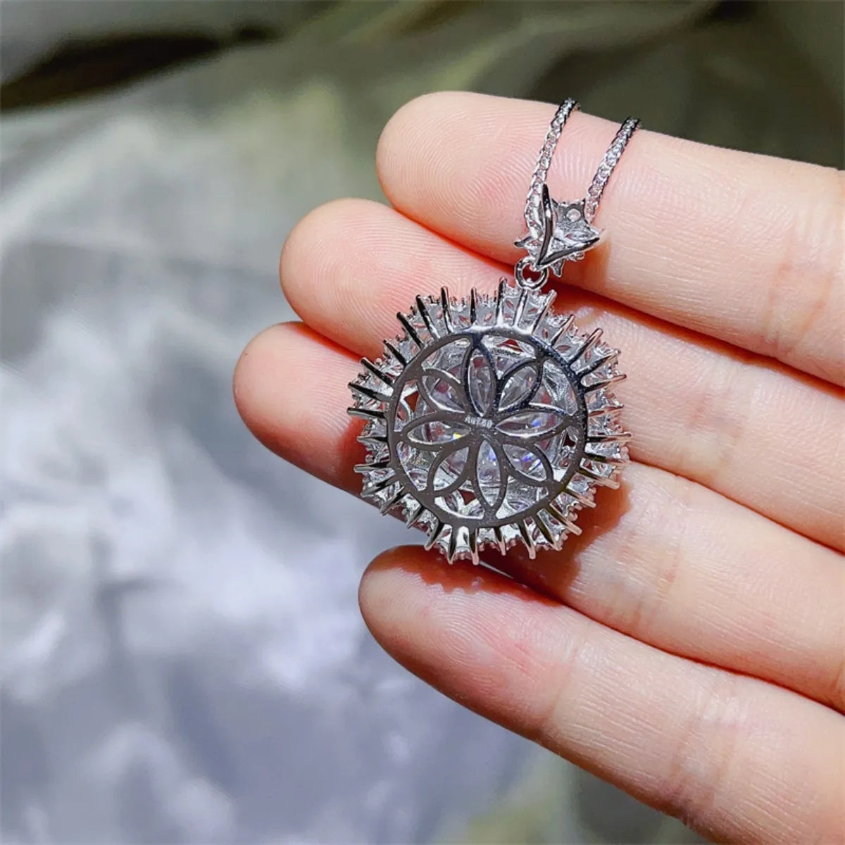 Radiant Cluster Pendant Necklace in white, featuring a floral-inspired design with sparkling stones.