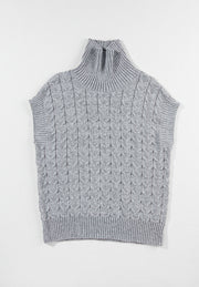 Gray cable knit turtleneck capelet sweater with ribbed trim and sleeveless design.