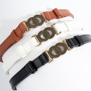 Interlocking buckle vegan leather belt in black, brown, and ivory with gold-tone hardware.