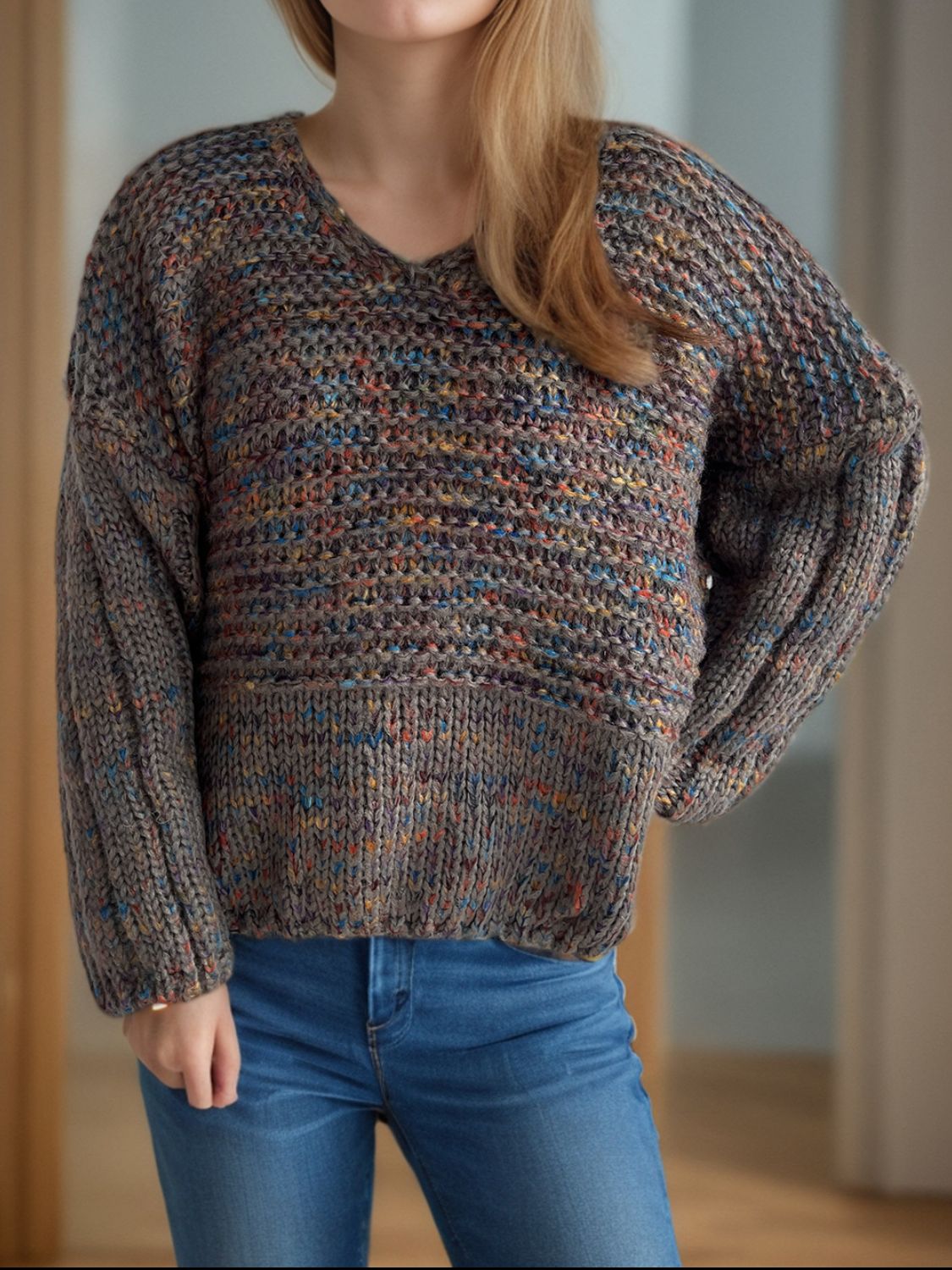 Textured knit sweater with balloon sleeves and V-neck in a speckled multicolor yarn.