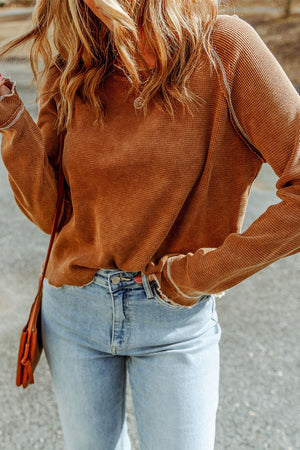 Caramel waffle knit raglan sweater with ruffled cuffs and contrast stitching.