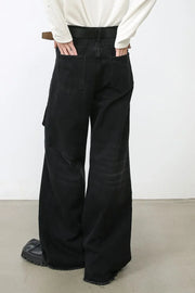Dark denim cargo pants with wide legs and frayed hems.