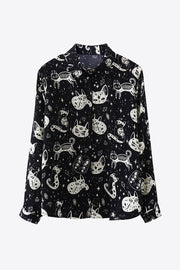 Black button-up blouse with a celestial cat print and long sleeves.