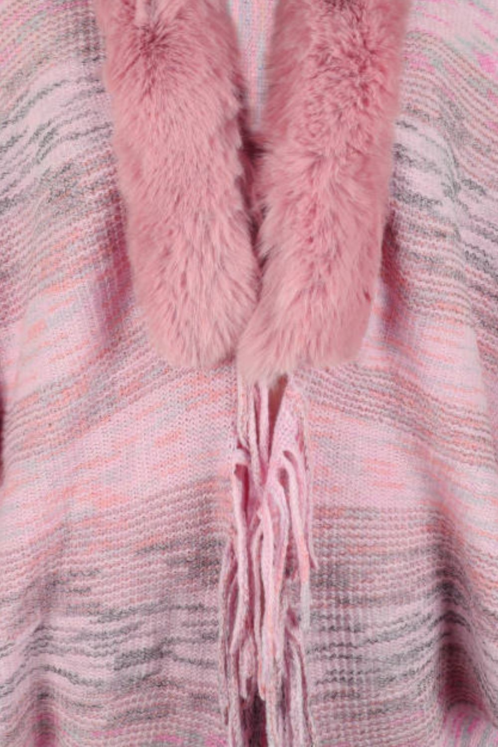 Textured knit cape in dusty pink with faux fur collar and fringe detail