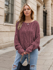 Mauve cable knit cocoon sweater with intricate textured pattern and wide sleeves.