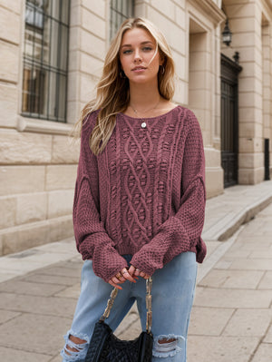 Mauve cable knit cocoon sweater with intricate textured pattern and wide sleeves.