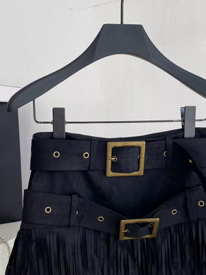 Black belted mini skirt with fringe hem and antique brass buckle detail.