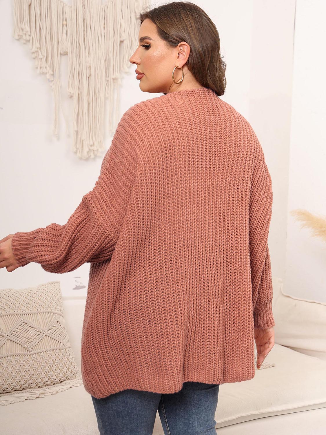 Chunky knit cardigan in coral with balloon sleeves and ribbed texture.