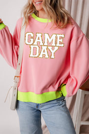 Pink sweatshirt with "GAME DAY" appliqué and neon trim